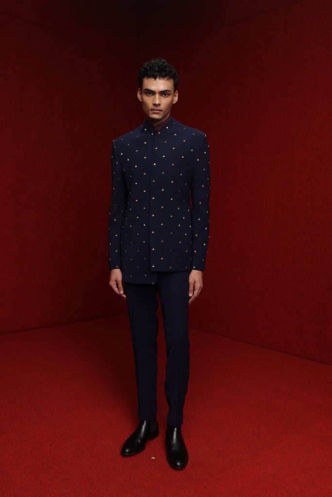 NAVY BLUE ASYM INDOWESTERN WITH ALL OVER MOTIF PAIRED WITH BURGUNDY BROAD STAND KURTA AND NAVY BLUE FITTED