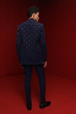 Navy blue asym indowestern with all over motif  paired with burgundy broad stand kurta and navy blue fitted pants