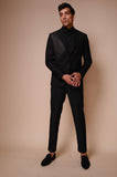 Black peak lapel suit with diagonal gold textured lines across chest