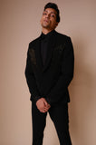 Black shawl lapel tuxedo with gold embroidery across chest